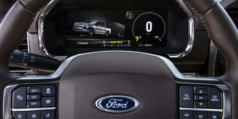 Close up shot of a 2023 Ford F-150's dash looking through the steering wheel. 